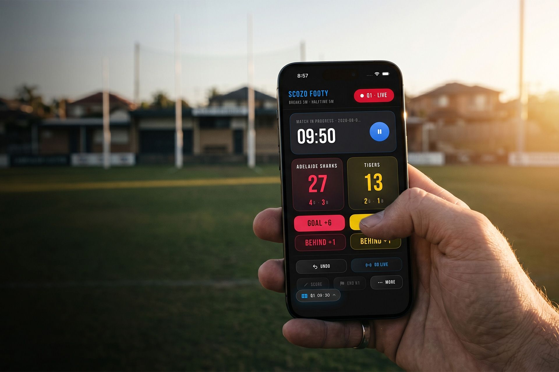 Volunteers and families following a live Aussie Rules footy score on the ScoZo app at a community ground